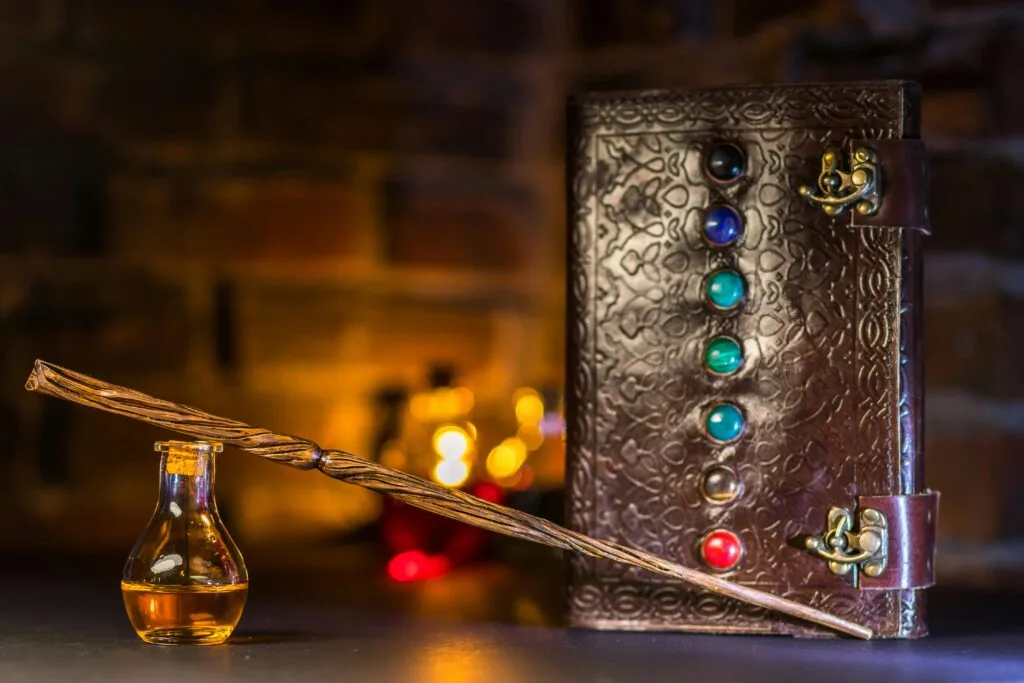 Close-up of a wizard's wand and potion with a magical spell book on a rustic background.
